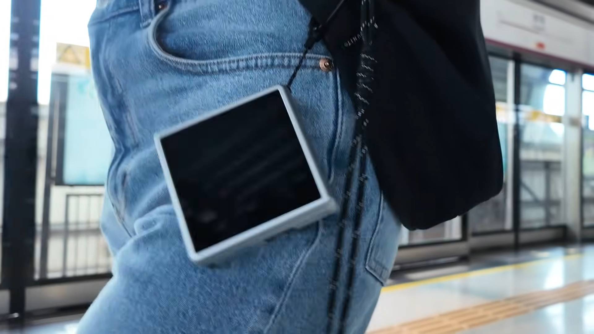 Anbernic RG Rotate hanging from belt loop.