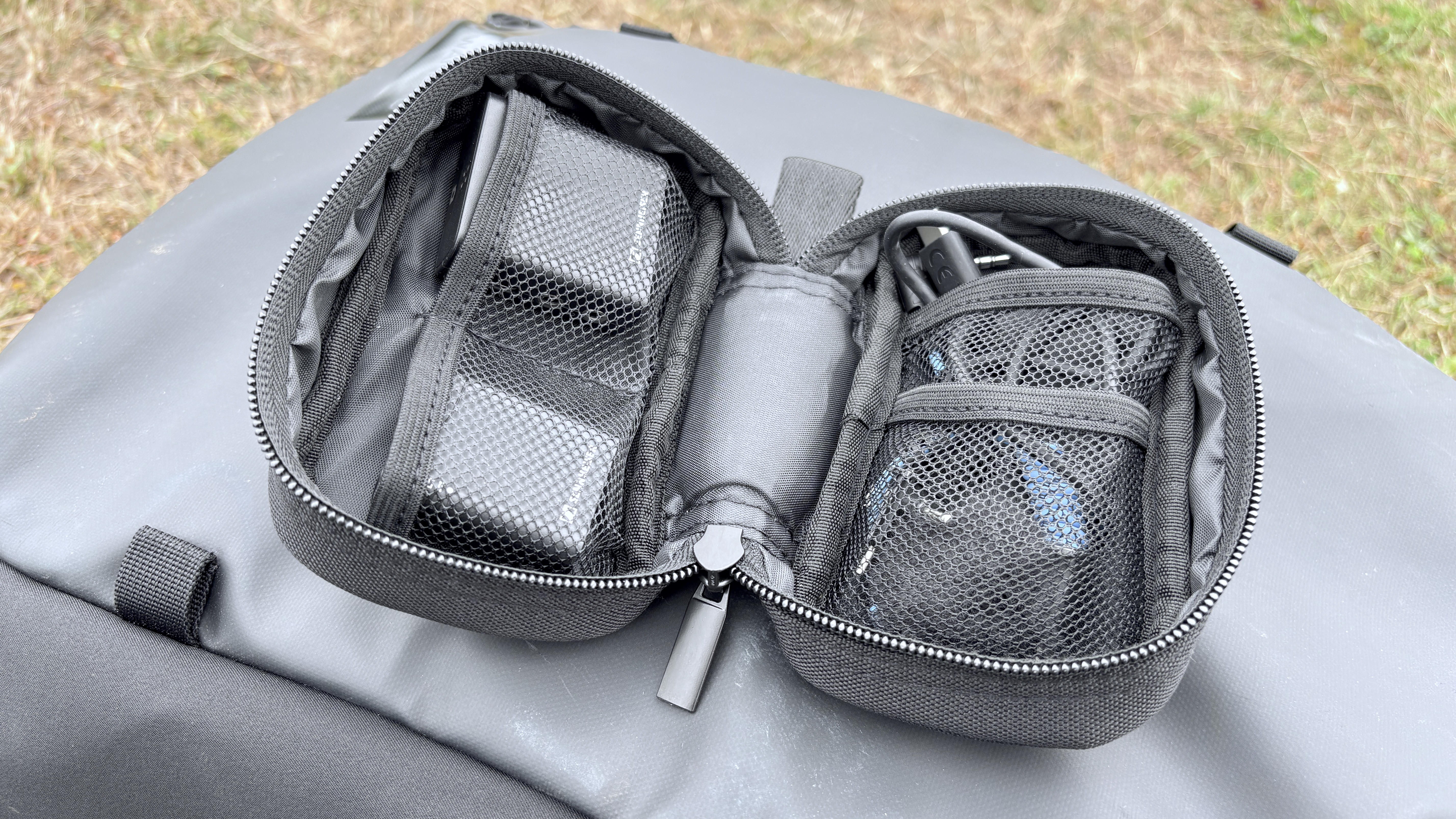 Shot of the Profile Wireless 1 kit’s soft black carry case which has been unzipped to reveal the interior’s webbed accessory pockets