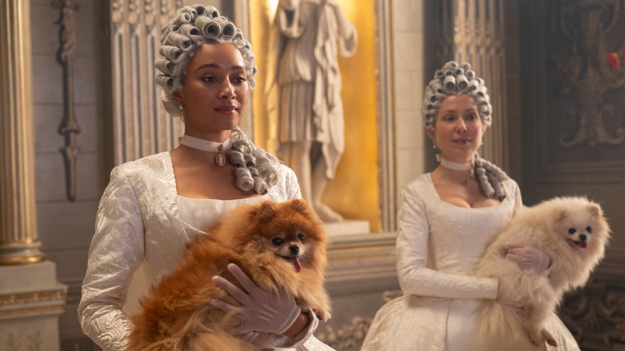 Alice Mondrich holdign a tiny dog as a lady in waiting.