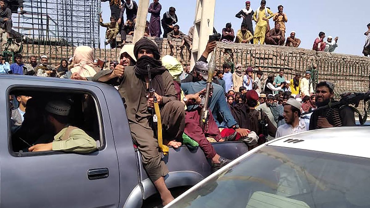 Taliban fighters sit on a vehicle along the street in Jalalabad province on Aug. 15, 2021.