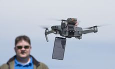 Tom's Guide testers get ready to drop a smartphone from a drone.