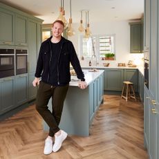 Greg Rutherford's kitchen with green cabinetry and a kitchen island