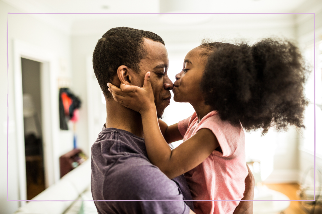 Daughter kissing father on the nose 