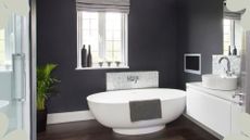 Black bathroom with white freestanding bath to support expert advice on the best dehumidifier for a bathroom