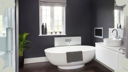 Black bathroom with white freestanding bath to support expert advice on the best dehumidifier for a bathroom