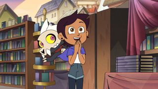 King sits on Luz's shoulder waving as Luz stands with an excited smile and her hands clasped together in The Owl House Episode "Sense and Insensitivity" 
