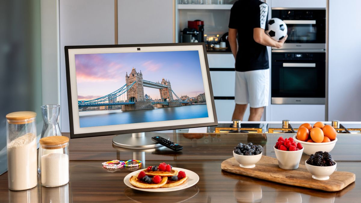 An Amazon Echo Show 21 on a kitchen table surrounded by food