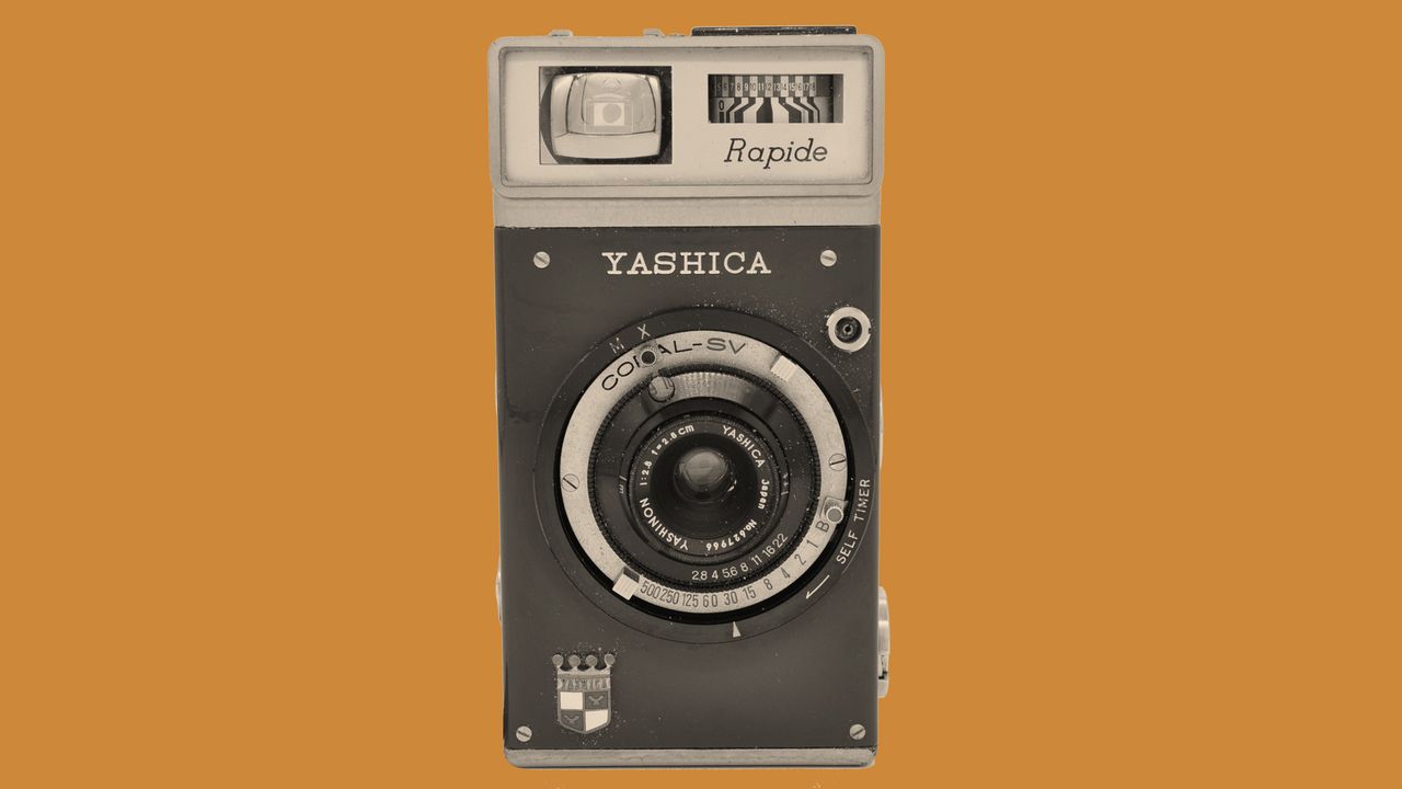 The front of the Yashica Rapide camera on a orange background