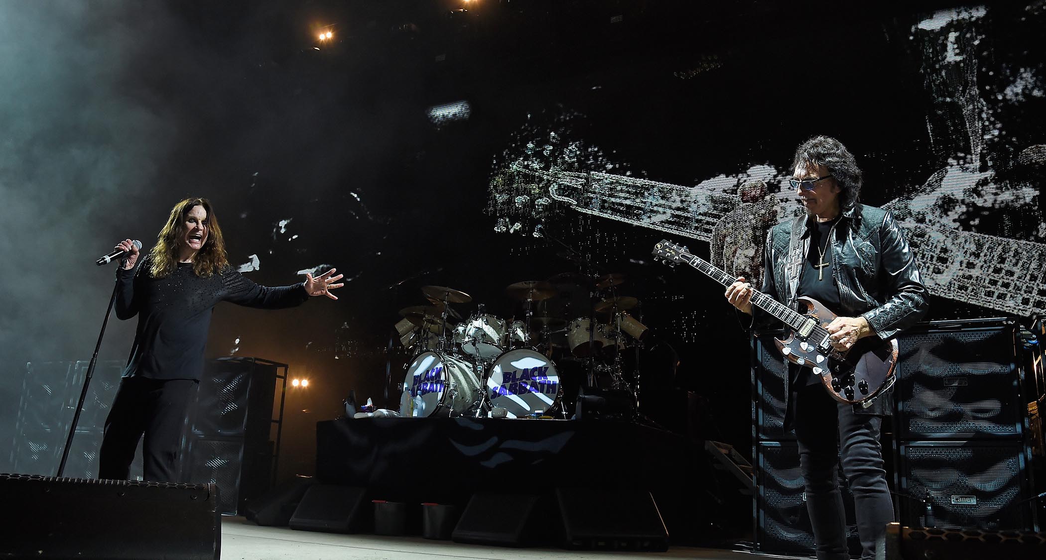 Black Sabbath live in 2016 on The End Tour: Frontman Ozzy extends a hand in appreciation of Tony Iommi mid-guitar solo.