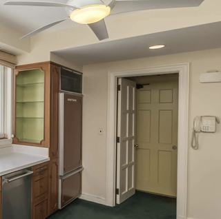 Ruth Jackson 60s kitchen before photo, with a ceiling fan, dated cabinets and green carpet