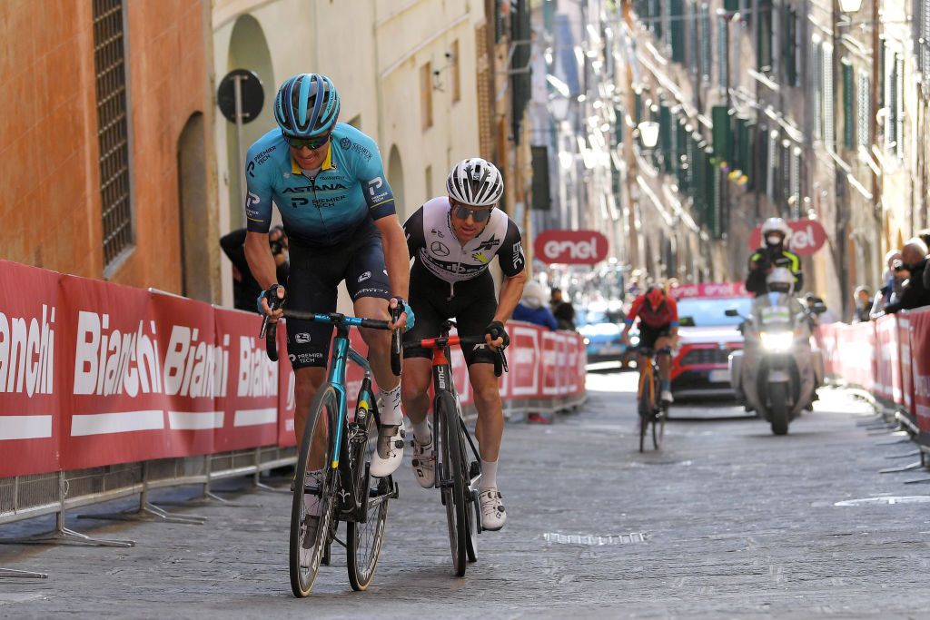 SIENA ITALY MARCH 06 Jakob Fuglsang of Denmark and Team Astana Premier Tech Simon Clarke of Australia and Team Qhubeka Assos during the Eroica 15th Strade Bianche 2021 Mens Elite a 184km race from Siena to Siena Piazza del Campo StradeBianche on March 06 2021 in Siena Italy Photo by Luc ClaessenGetty Images