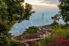 Curvy elevated skywalk and Taipei City on the mountain