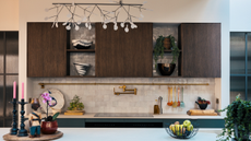 beautiful kitchen counter with white zellige tile backsplash and wooden cabinets
