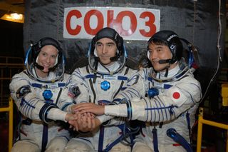 NASA astronaut Kate Rubins, Russian cosmonaut Anatoly Ivanishin and JAXA astronaut Takuya Onishi pose during training before their July 6 launch to the International Space Station. Rubins and Onishi are both first-time fliers.