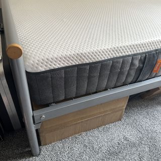 The edge of the Emma NextGen Premium mattress on a grey metal bedframe