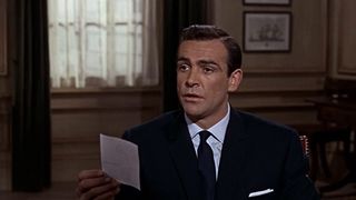 Sean Connery's James Bond looks shcoked as he looks at a note in From Russia With Love