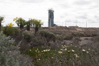 The natural terrain on Vandenberg Air Force Base in California provides a stark contrast to the steel launch tower on Space Launch Complex 2 where preparations are underway for the upcoming launch of NASA's Orbiting Carbon Observatory-2 mission, or OCO-2, aboard a United Launch Alliance Delta II rocket in July. Photo released April 4, 2014.