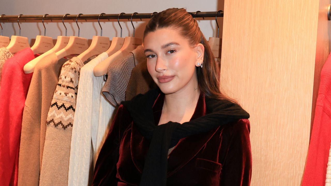 Hailey Bieber wearing burgundy at an event