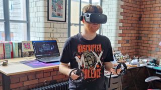 Man playing with HP Reverb G2 VR headset and controllers. He is in a ready stance.