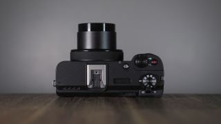 Canon PowerShot V1 on a wooden surface