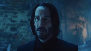 John Wick looking across at Eve Macarro outside in snowy village in Ballerina