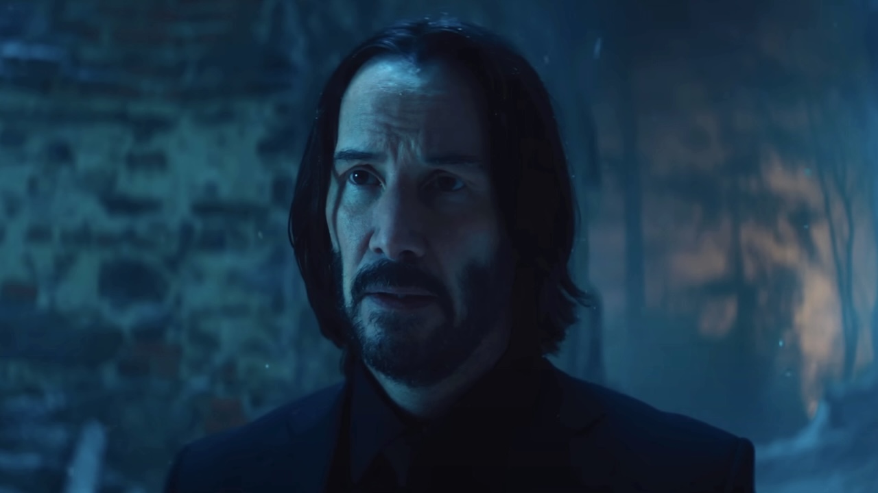 John Wick looking across at Eve Macarro outside in snowy village in Ballerina