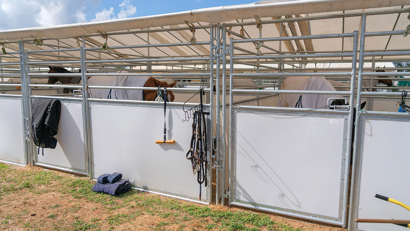 2F4E4Y9 Temporary stables for horses with equipment hanging on exterior,