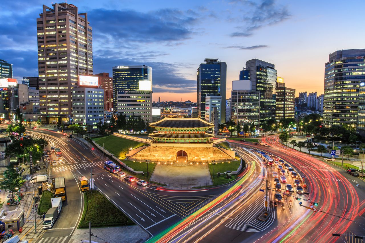 Old fortress gate with light trails in busy Seoul, an emerging Asian market