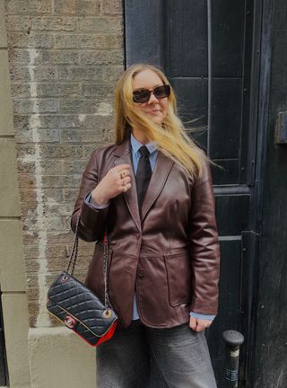 Copelyn Bengel in a Quince leather blazer and Quince blue button down shirt.