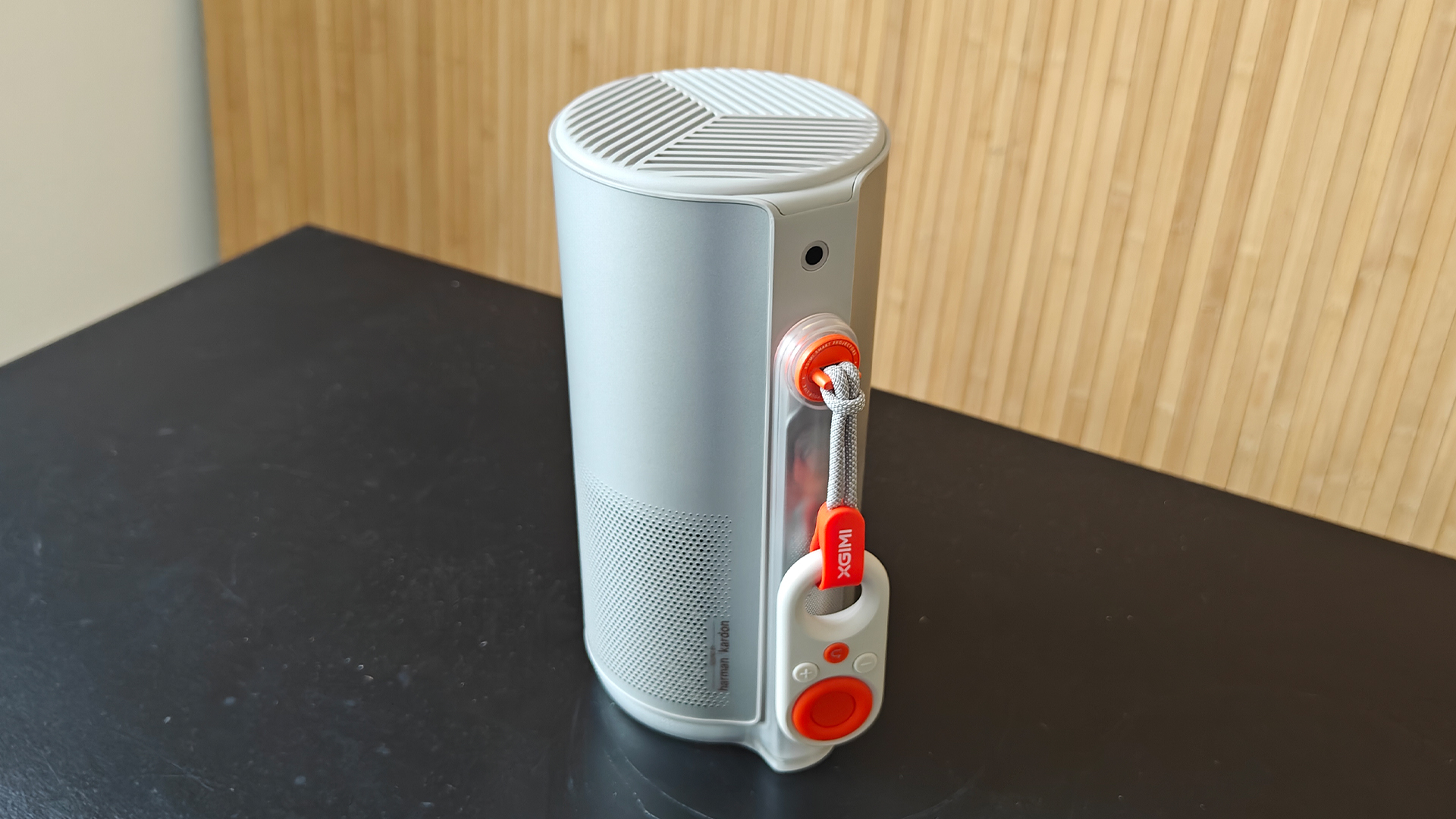 Xgimi MoGo 4 portable projector upright on black wood surface