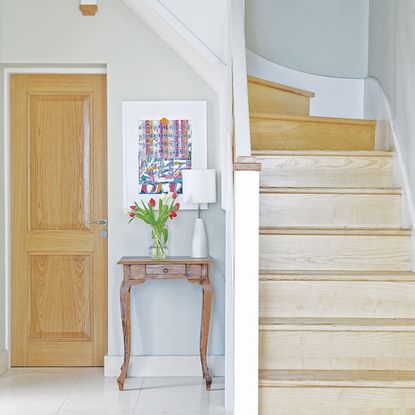 photo frame and wooden table near wooden stairs 