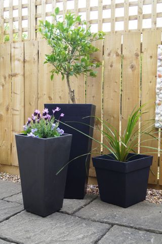 how to create an eco-friendly garden: trio of plant pots made from recycled materials
