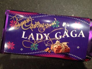 Lady Gaga signs a chocolate bar for the Beckham family