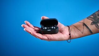 A pair of black Status Pro X wireless earbuds