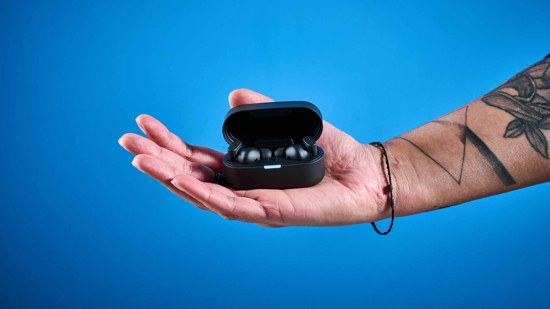 A pair of black Status Pro X wireless earbuds