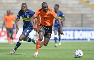 Deon Hotto of Orlando Pirates pulls away from Thamsanqa Mkhize of Cape Town City 