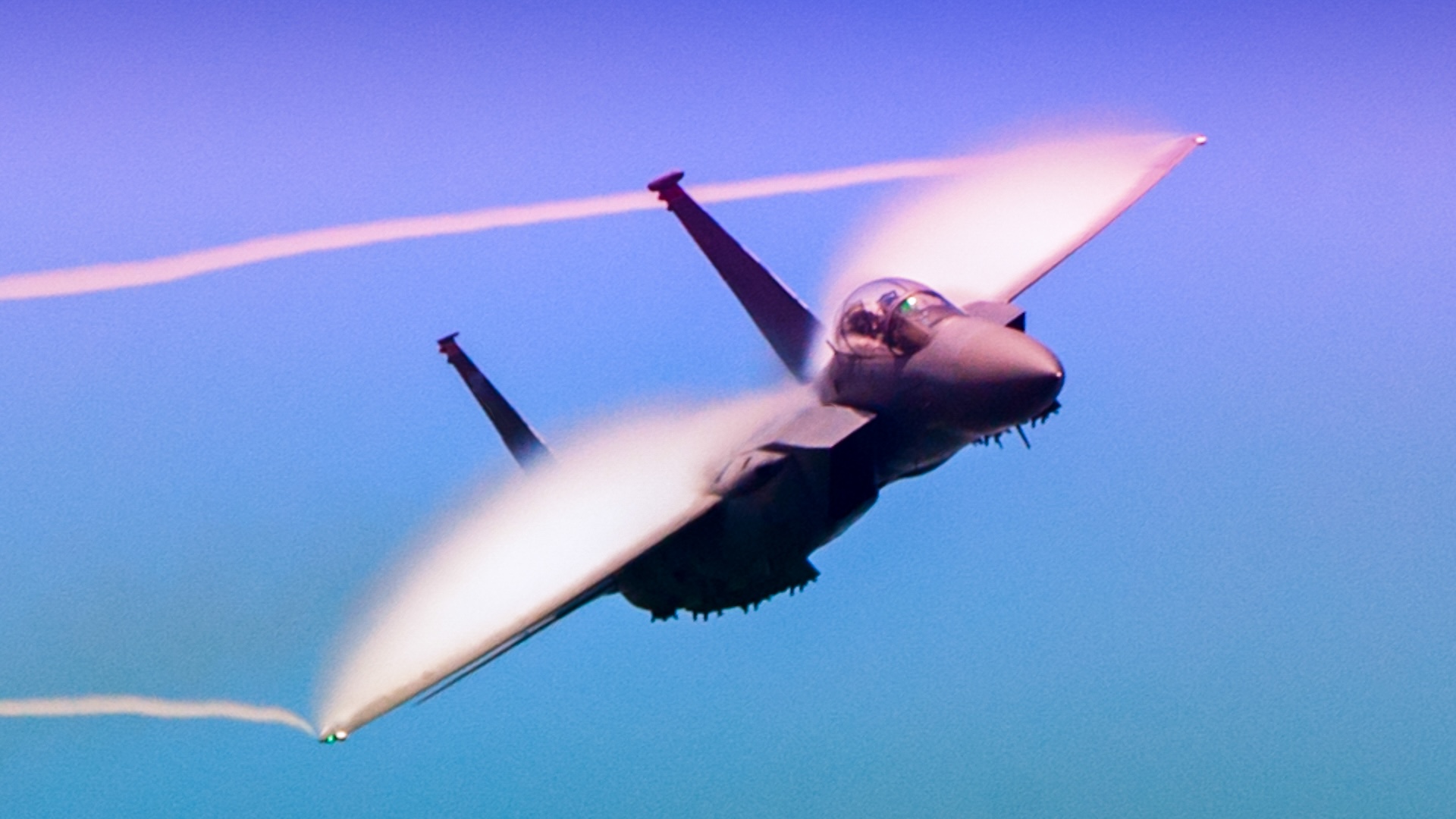 F18 superhornet flying across a blue sky