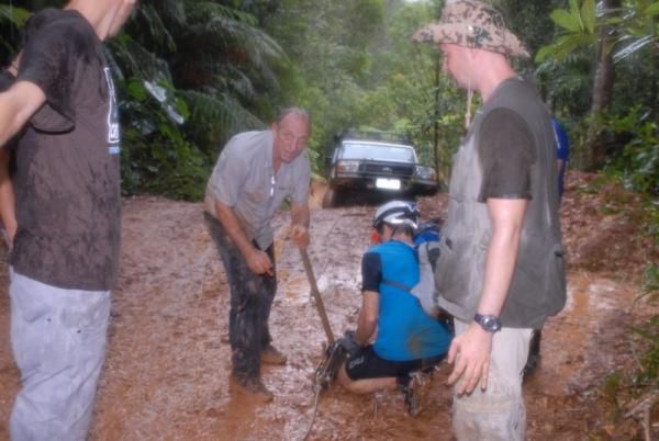 The support crew works to free a stuck truck out on course