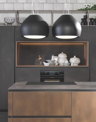 dark black kitchen with wood kitchen cabinets with large pendant lights