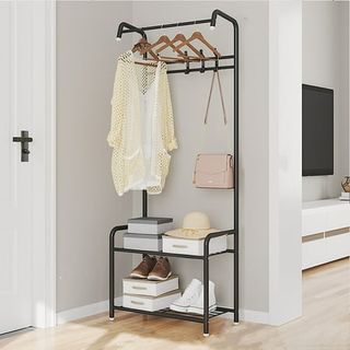 A black metal coat hook unit with a shoe rack beneath