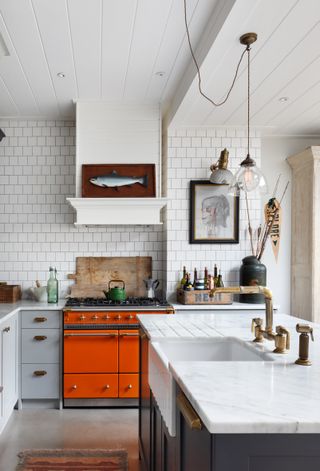 Kitchen with white metro tiles and prints on walls