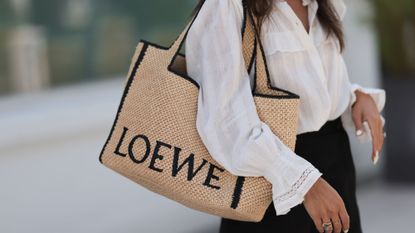 Woman holding a Loewe basket bag GettyImages-1632126608