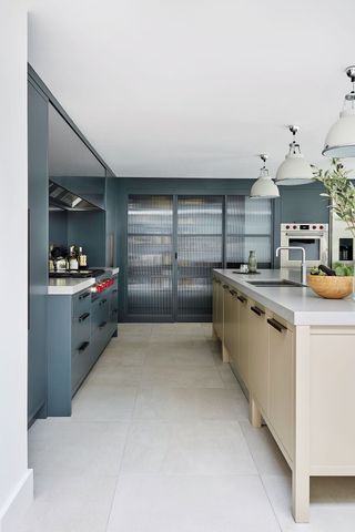 Grey kitchen cabinets painted in Farrow & Ball Downpipe with beige kitchen island