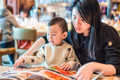 Woman and child at a restaurant as the rule of six including children comes into play