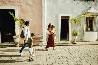 Family, including two children, walking around a quiet town while on holiday