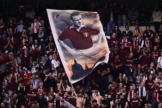 A fan waves a banner displaying former Torino player Valentino Mazzola, who died aged 30 in a plane crash in 1949, during the Italian Serie A football match between Torino and Napoli on May 7, 2022 at the Olympic stadium in Turin.