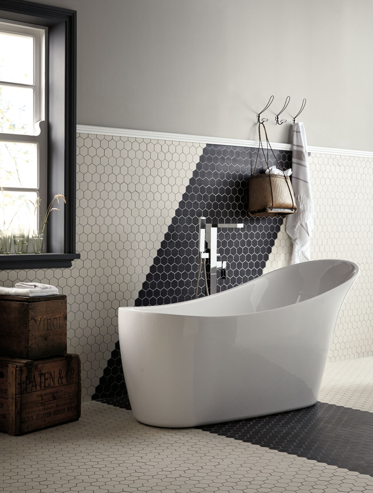 A black and white bathroom with hexagon tiles