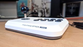 Hori Fighting Stick Mini on desk surface showing the front of the controller