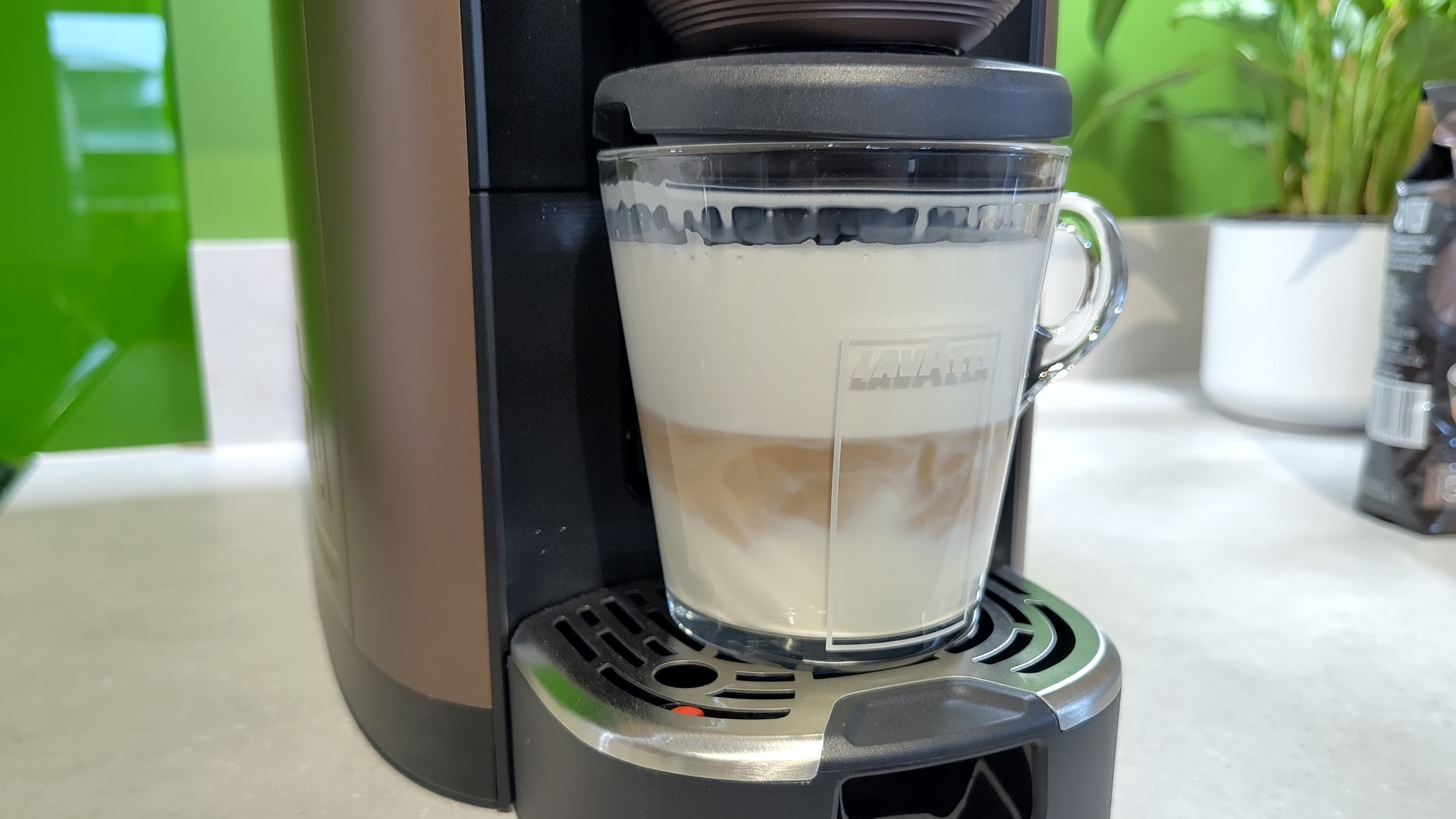 Lavazza Assoluta machine pouring espresso into foamed milk