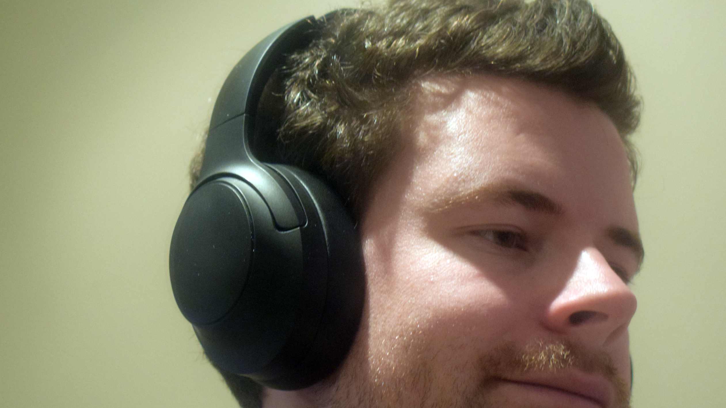The Soundpeats Cove Pro on a man's head.